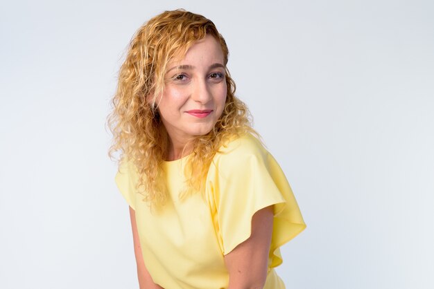 Portrait of beautiful woman with curly blond hair on white