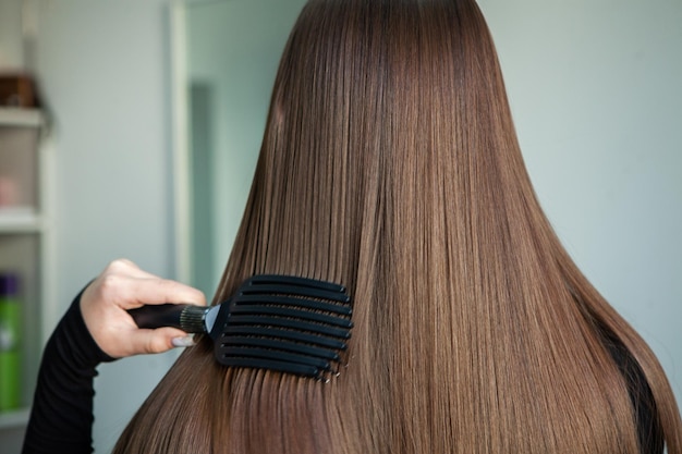 Portrait of a beautiful woman with long brown straight hair in a beauty salon