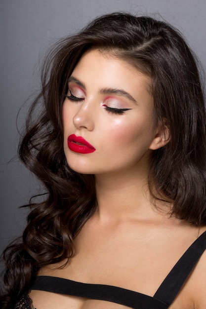 Portrait of beautiful woman with make-up and curly hair