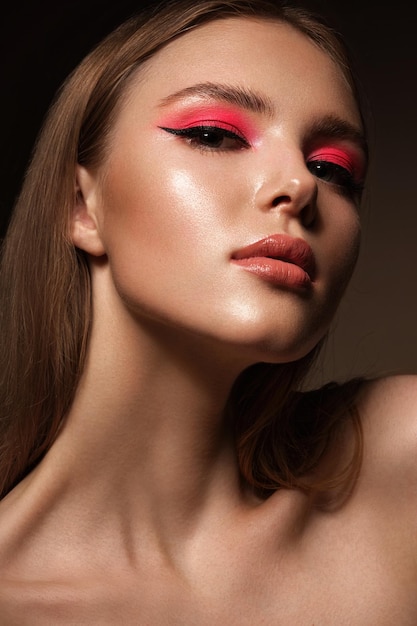 Portrait of a beautiful woman with pink creative make up Beauty face