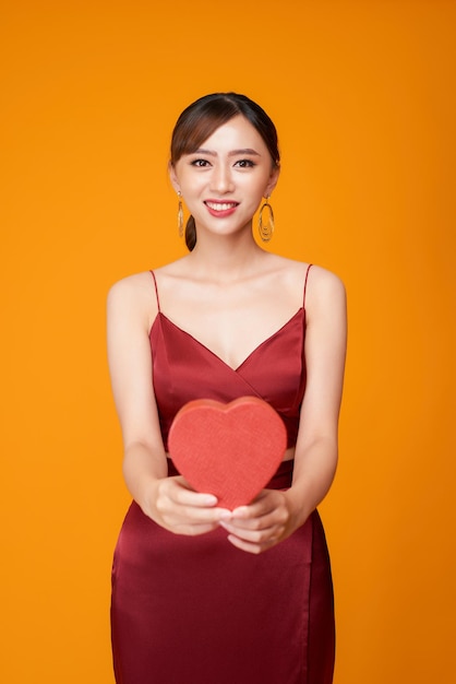 Portrait of Beautiful woman with red heart shaped box