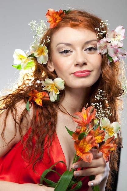 Portrait of beautiful woman with spring flowers