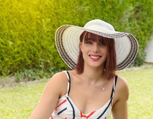 Portrait of a beautiful woman with summer hat