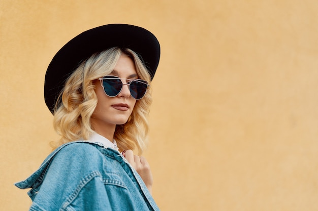 portrait beautiful woman with sunglasses and a hat outdoor