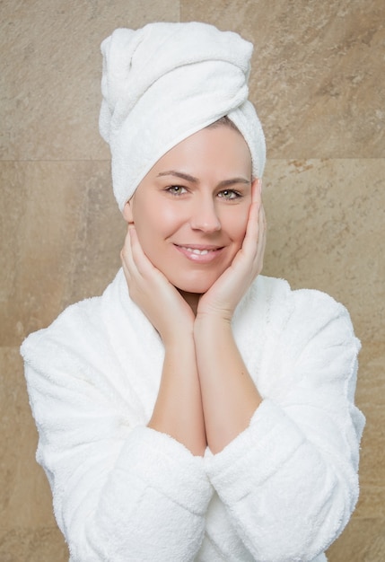 Photo portrait of beautiful woman with a white bathrobe