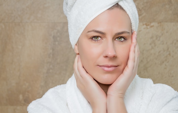 Portrait of beautiful woman with a white bathrobe