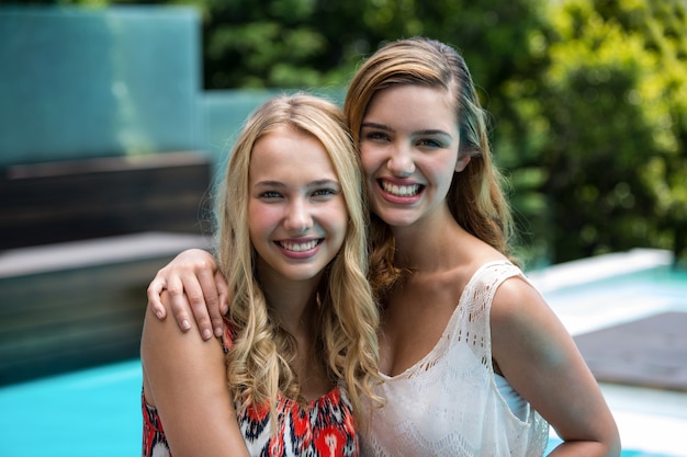 Portrait of beautiful women having fun near pool