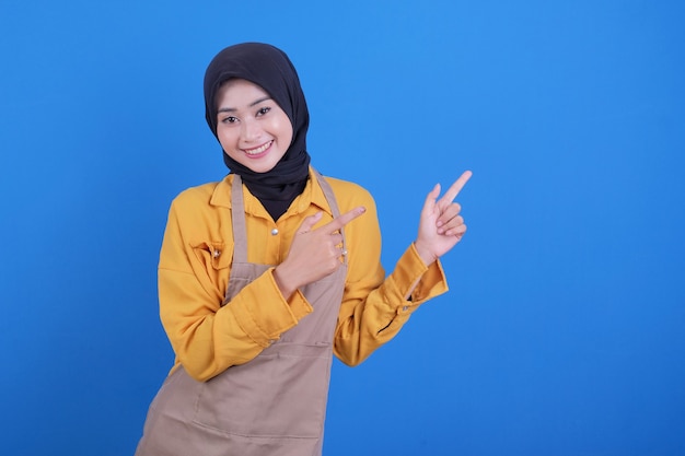 Portrait beautiful young asian woman pointing something blue