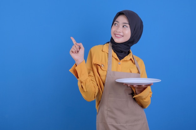 Portrait beautiful young asian woman show empty dish pointing up