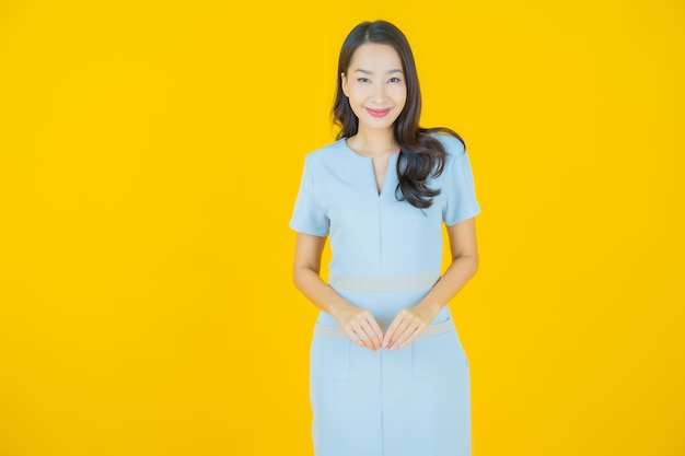 Portrait beautiful young asian woman smile with action on color background