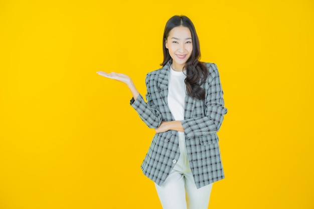 Portrait beautiful young asian woman smile with action on color background