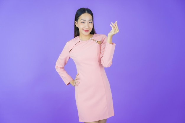 Photo portrait beautiful young asian woman smile with action on color background