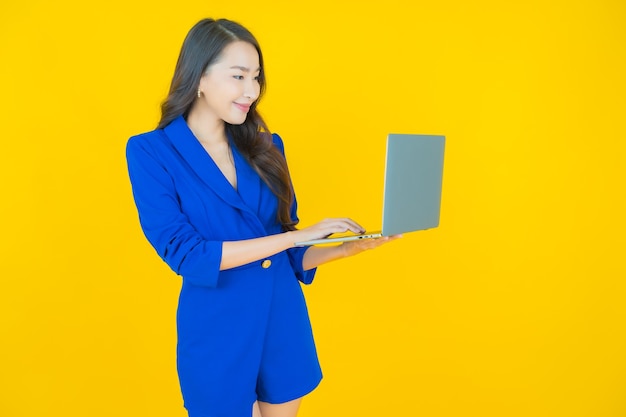 Portrait beautiful young asian woman smile with computer laptop on isolated background