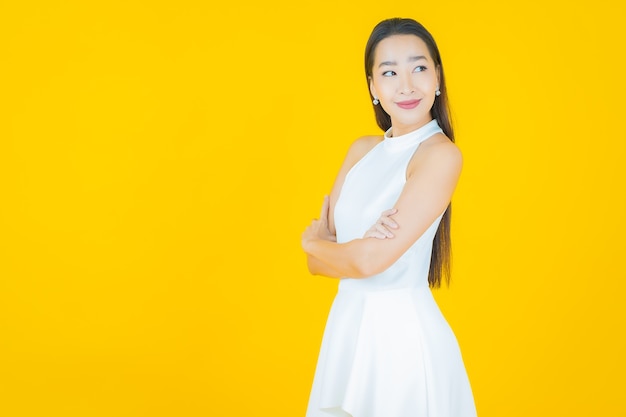 Portrait beautiful young asian woman smile on yellow