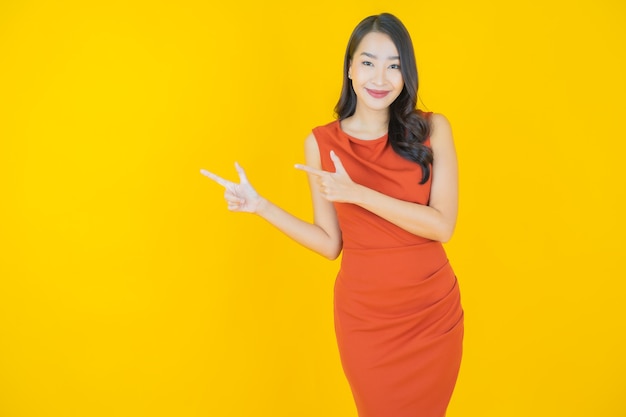 Portrait beautiful young asian woman smile on yellow