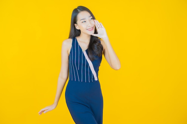 Portrait beautiful young asian woman smile on yellow