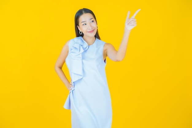 Portrait beautiful young asian woman smiling on yellow