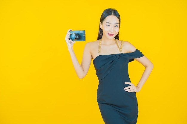 Portrait of beautiful young asian woman use camera