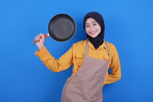 Portrait beautiful young asian woman wear apron with black pan