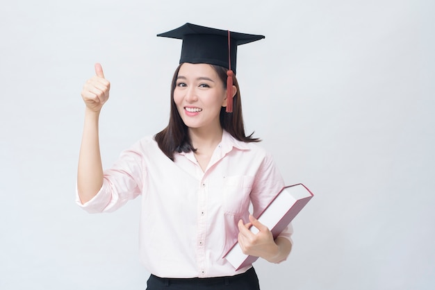 A portrait of beautiful young asian woman with education cap , education concept .