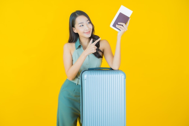 Portrait of beautiful young asian woman with luggage bag and passport ready for travel