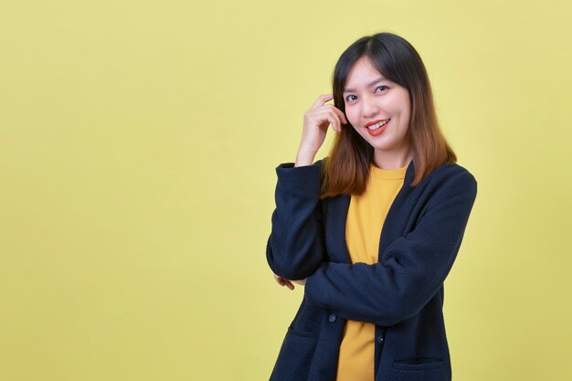 Portrait of beautiful young Asian on yellow background