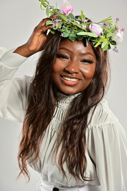 portrait of beautiful young black woman with flower wreath on her head