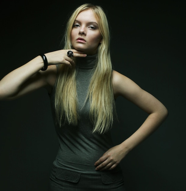 Portrait of beautiful young blonde girl in black dress