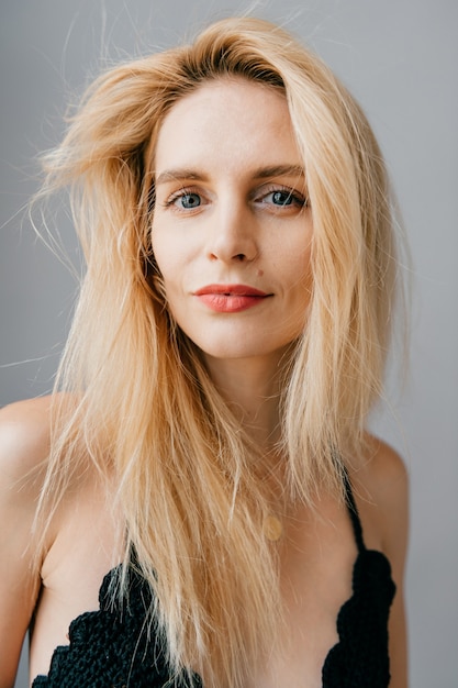 Portrait of beautiful young blonde model posing in studio