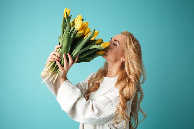 Portrait of a beautiful young blonde woman in sweater