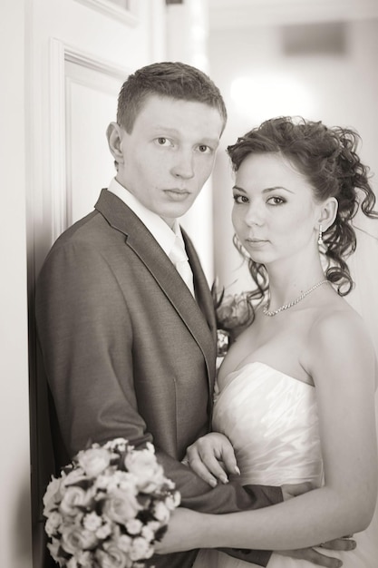 Portrait of a beautiful young bride smiling on her wedding day w