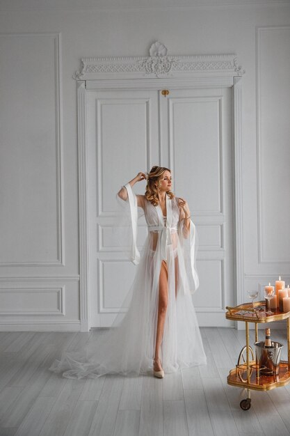 portrait of a beautiful young bride in a white wedding dress in a chic interior