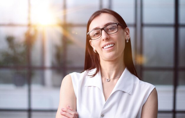 Portrait of a beautiful young business woman in glasses posing in the office