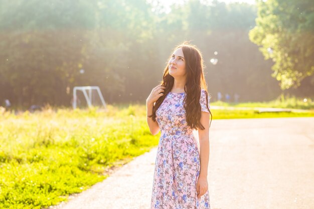 Portrait of a beautiful young caucasian dreaming woman outdoor in summer