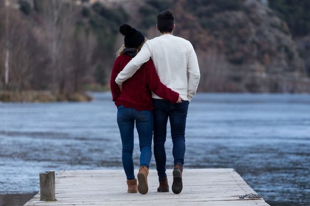 Photo portrait of beautiful young couple in love over winter background.