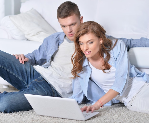 Portrait of a beautiful young couple with a laptop