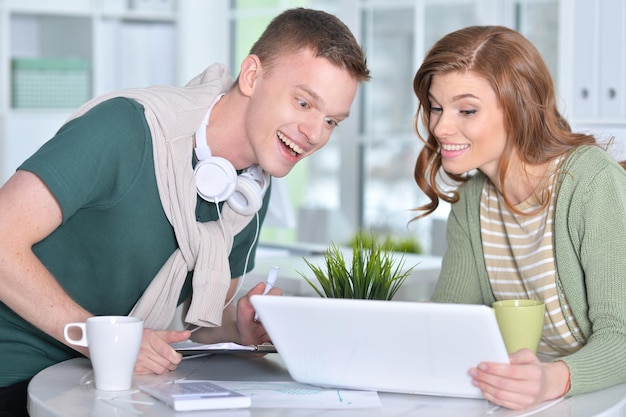 Portrait of a beautiful young couple with a laptop