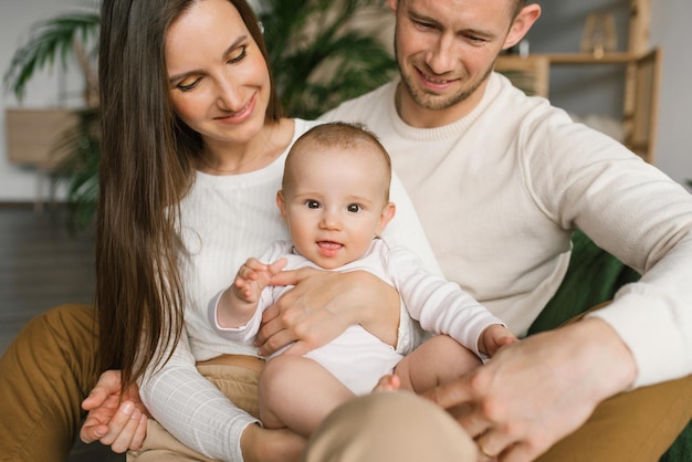 Portrait of a beautiful young family with a baby at home