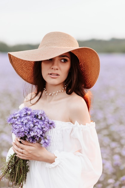 Portrait of a beautiful young girl in a blooming field of provence