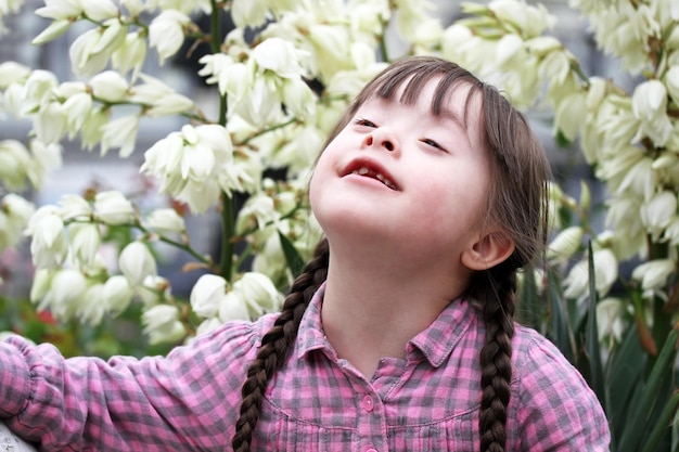 Portrait of beautiful young girl on flowers background