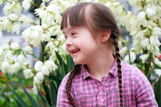 Portrait of beautiful young girl on flowers background