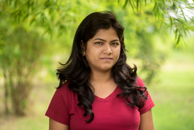 Portrait of beautiful Young girl outdoors in park.