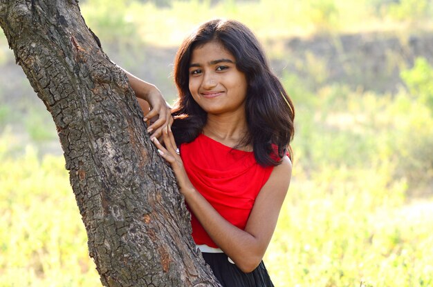 Portrait of beautiful young girl in park posing.