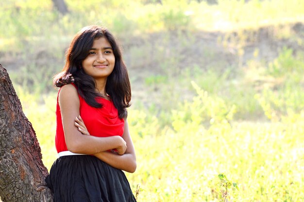 Portrait of beautiful young girl in park posing.