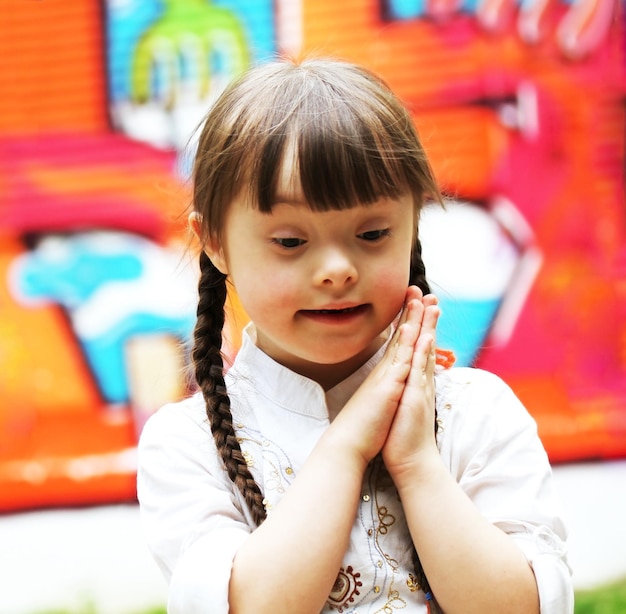 Portrait of beautiful young girl praying