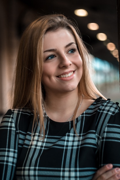 Portrait of a beautiful young girl on the train station