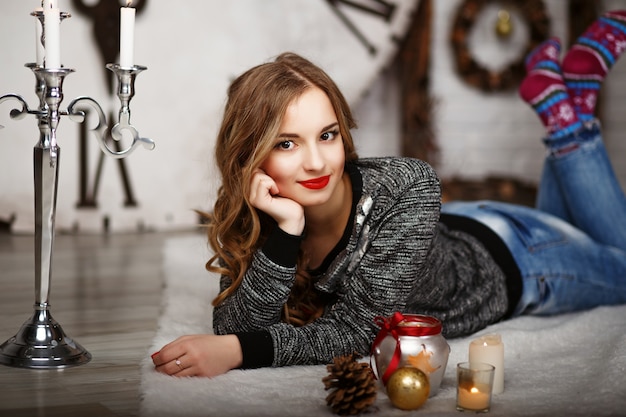 Portrait of a beautiful young girl with elegant Christmas decorations