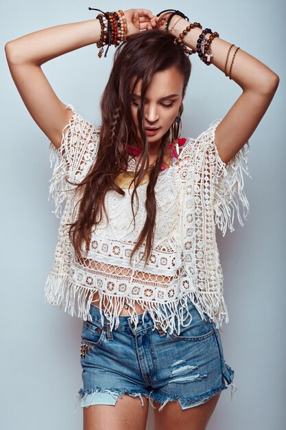 Portrait of beautiful young hippie woman in studio