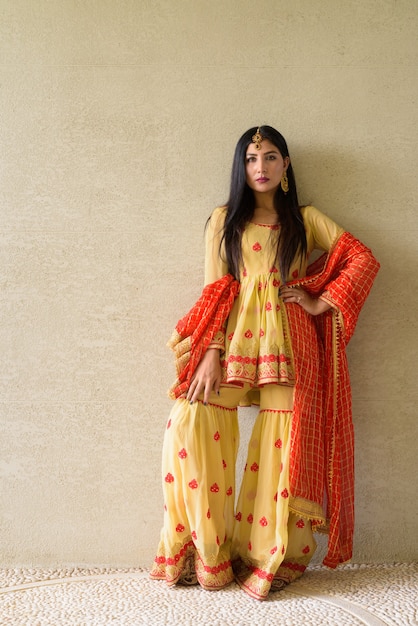 Portrait of beautiful young Indian woman wearing traditional clothes outdoors