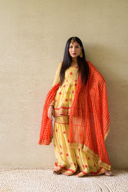 Portrait of beautiful young Indian woman wearing traditional clothes outdoors